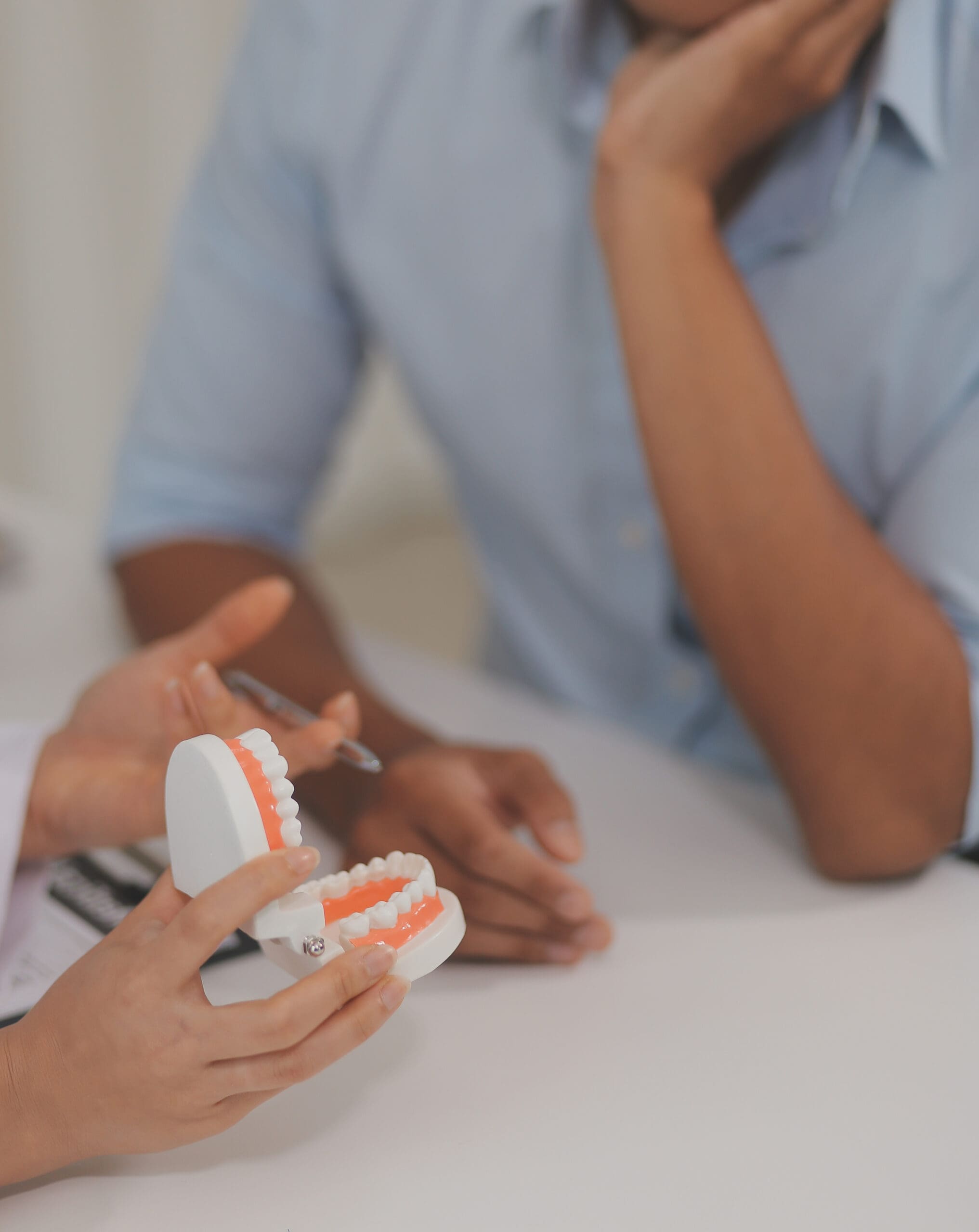 Elkhart periodontist explaining gum recession and periodontal disease treatment options to a patient during a consultation.